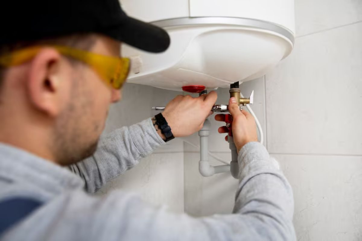 Plumber repairing a residential water heater